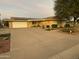 Front view of a single-story home with a driveway and mature landscaping at 10102 W Gulf Hills Dr, Sun City, AZ 85351