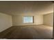 Spacious living room with large windows and neutral carpeting at 10102 W Gulf Hills Dr, Sun City, AZ 85351