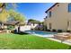 Large backyard with swimming pool, lawn, and lounge chairs at 10191 E Diamond Rim Dr # 2122, Scottsdale, AZ 85255