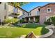 Landscaped backyard showcasing a large lawn and stone pathway at 10191 E Diamond Rim Dr # 2122, Scottsdale, AZ 85255