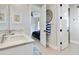 Bathroom with double vanity, marble countertop, and view of bedroom at 10191 E Diamond Rim Dr # 2122, Scottsdale, AZ 85255