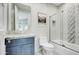 Bathroom with a blue vanity, marble countertop, and shower/tub combo at 10191 E Diamond Rim Dr # 2122, Scottsdale, AZ 85255