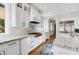 Modern kitchen with white cabinets, marble countertops, and stainless steel appliances at 10191 E Diamond Rim Dr # 2122, Scottsdale, AZ 85255