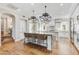 Spacious kitchen featuring an island, hardwood floors, and white cabinets at 10191 E Diamond Rim Dr # 2122, Scottsdale, AZ 85255