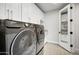 Laundry room with Samsung washer and dryer, and additional storage at 10191 E Diamond Rim Dr # 2122, Scottsdale, AZ 85255
