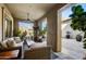 Relaxing covered patio with wicker seating, wooden coffee table, and potted plants at 10191 E Diamond Rim Dr # 2122, Scottsdale, AZ 85255