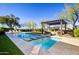 Luxury backyard oasis with a large pool, pergola, and seating area at 10191 E Diamond Rim Dr # 2122, Scottsdale, AZ 85255