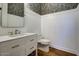 Elegant powder room with white vanity and floral wallpaper at 10191 E Diamond Rim Dr # 2122, Scottsdale, AZ 85255