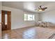 Living room featuring tile floors, a ceiling fan, and a wood door at 11029 W Cherry Hills Dr, Sun City, AZ 85351