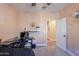 Bedroom with a desk, chair, and view of hallway at 11543 E Starkey Ave, Mesa, AZ 85212