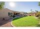 Large backyard with grassy area and a stone water feature at 13204 W Palo Verde Dr, Litchfield Park, AZ 85340