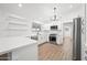 Modern white kitchen with new appliances and light wood flooring at 1739 W Joy Ranch Rd, Phoenix, AZ 85086