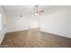 Spacious living room featuring wood-look floors and ceiling fan at 1739 W Joy Ranch Rd, Phoenix, AZ 85086