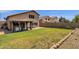 Private backyard with grassy area and covered patio at 18110 N Skyhawk Dr, Surprise, AZ 85374