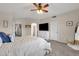 Primary bedroom with a dresser, TV, and access to other rooms at 18110 N Skyhawk Dr, Surprise, AZ 85374