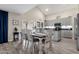 Bright dining room with farmhouse style table and chairs, adjacent to the kitchen at 18110 N Skyhawk Dr, Surprise, AZ 85374