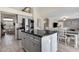 Modern kitchen with granite island, stainless steel appliances, and gray cabinets at 18110 N Skyhawk Dr, Surprise, AZ 85374