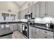 Modern kitchen boasts granite countertops, gray cabinets, and ample counter space at 18110 N Skyhawk Dr, Surprise, AZ 85374