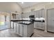 Modern kitchen with gray cabinets, granite island, and stainless steel appliances at 18110 N Skyhawk Dr, Surprise, AZ 85374