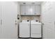 Laundry room with washer, dryer, and overhead cabinets at 18110 N Skyhawk Dr, Surprise, AZ 85374