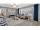 Living room with hardwood floors, comfortable seating, and large windows at 18110 N Skyhawk Dr, Surprise, AZ 85374