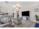 Spacious living room with large TV, comfortable seating, and an open floor plan at 18110 N Skyhawk Dr, Surprise, AZ 85374