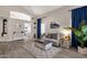 Open living room with view into kitchen, hardwood floors, and seating at 18110 N Skyhawk Dr, Surprise, AZ 85374