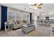 Open living room features a cozy sofa and a view into the kitchen and dining area at 18110 N Skyhawk Dr, Surprise, AZ 85374