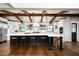 Modern kitchen with large island, white cabinets, and exposed wooden beams at 1838 Palmcroft Nw Way, Phoenix, AZ 85007