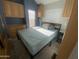 Bedroom with a double bed, built-in cabinets and a small side table at 2205 W Klamath Ave, Apache Junction, AZ 85119