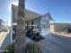 Mobile home exterior with carport, golf cart, and desert landscaping at 2205 W Klamath Ave, Apache Junction, AZ 85119