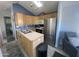 Open kitchen with stainless steel appliances and light wood cabinets at 2205 W Klamath Ave, Apache Junction, AZ 85119