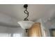 Close-up of an ornate, hanging light fixture with a frosted glass shade at 2205 W Klamath Ave, Apache Junction, AZ 85119