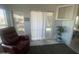 Living area with red recliner, sliding glass door, and plant at 2205 W Klamath Ave, Apache Junction, AZ 85119