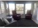Sunlit living room with three comfy armchairs and large windows at 2205 W Klamath Ave, Apache Junction, AZ 85119