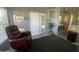 Living room with red recliner, sliding glass door, and partial kitchen view at 2205 W Klamath Ave, Apache Junction, AZ 85119