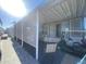Covered patio with retractable awning and golf cart at 2205 W Klamath Ave, Apache Junction, AZ 85119
