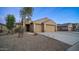 Two-story home with a two-car garage and desert landscaping at 22325 N 185Th Ave, Surprise, AZ 85387