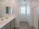 Modern bathroom with double sinks, a large mirror, and a walk-in shower at 22862 E Bonanza Way, Queen Creek, AZ 85142