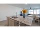 Granite kitchen island with sink and dishwasher; open floor plan at 22862 E Bonanza Way, Queen Creek, AZ 85142