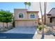 Tan two-story stucco home with two-car garage and desert landscaping at 25609 N Forest Rd # 13, Rio Verde, AZ 85263