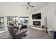 Bright living room with gray sectional sofa, fireplace, and wood-look floors at 25609 N Forest Rd # 13, Rio Verde, AZ 85263