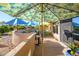 Outdoor patio with seating area under a patterned umbrella and views of the landscape at 25609 N Forest Rd # 13, Rio Verde, AZ 85263