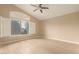 Spacious bedroom with vaulted ceiling, large window with shutters, and ceiling fan at 2731 W Shannon Ct, Chandler, AZ 85224