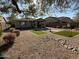 Landscaped backyard with artificial turf and rock features at 2816 W Pollack St, Phoenix, AZ 85041