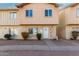 Tan two-story townhome with a small front yard and walkway at 3605 W Bethany Home Rd # 21, Phoenix, AZ 85019