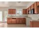 Kitchen with wood cabinets, tile backsplash, and stainless steel appliances at 3605 W Bethany Home Rd # 21, Phoenix, AZ 85019