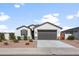 Single-story home with a two-car garage and desert landscaping at 36204 W San Sisto Ave, Maricopa, AZ 85138