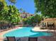 Refreshing community pool with surrounding lounge chairs at 5104 N 32Nd St # 129, Phoenix, AZ 85018