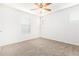 Well-lit bedroom featuring ceiling fan and carpet at 5230 W Odeum Ln, Phoenix, AZ 85043